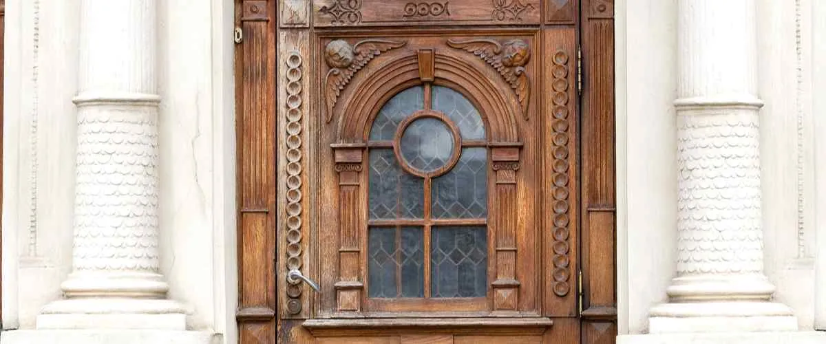 panelled wooden jali door design with a glass insert