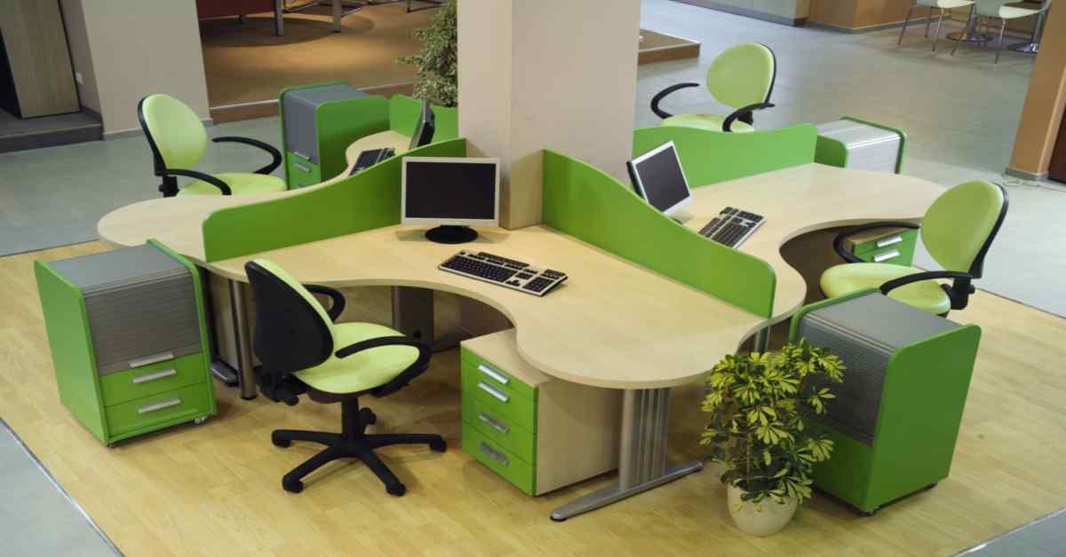 cubicle-with-green-desks-and-green-chairs-in-a-brightly-lit-office-in-india