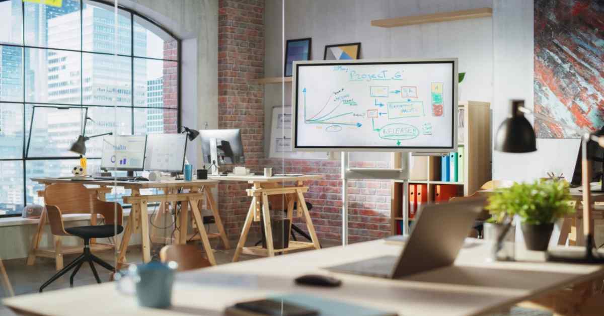 Modern small office with art on walls and desks with computers